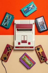 a nintendo game console surrounded by various game controllers