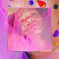 an image of a girl laying on a pink blanket